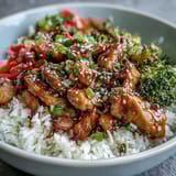 Tender glazed Honey Garlic Chicken Bowl with crisp vegetables and rice, ready to serve for an easy weeknight dinner.