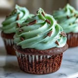 Festive green velvet cupcakes with cocoa and cream cheese frosting, perfect for St. Patrick's Day celebrations.