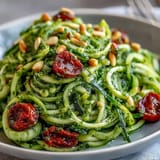 Fresh spiralized zucchini noodles coated in luscious avocado pesto, perfect light dinner.