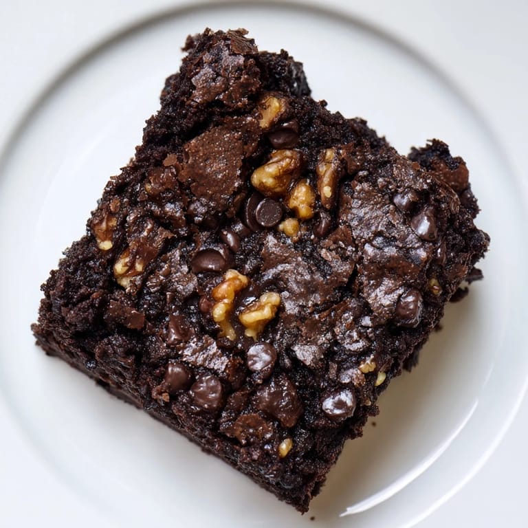 Cutting into a pan of perfect brownies, ready to enjoy with a scoop of vanilla ice cream or a glass of milk.