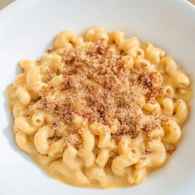 Creamy macaroni and cheese, steaming hot, with a rich cheese sauce and perfectly cooked pasta.