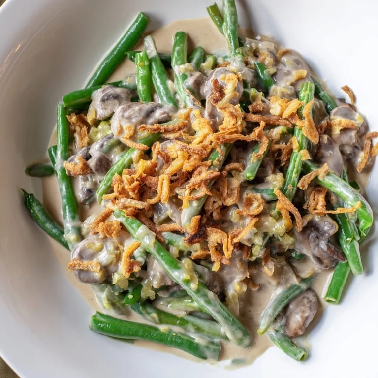 A warm baking dish filled with homemade Green Bean Casserole, a comforting American classic for dinner.
